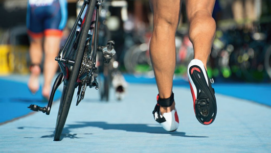 triathlonist-runs-on-bicycle-in-transition-zone-530x300.jpg